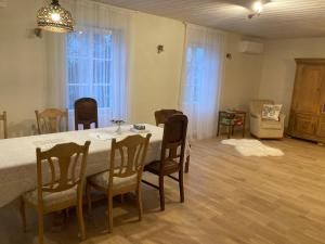 a dining room with a table and chairs at Lauku māja Akmeņkalni in Daugmale