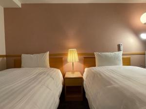 Postel nebo postele na pokoji v ubytování Toyoko Inn Busan Seomyeon