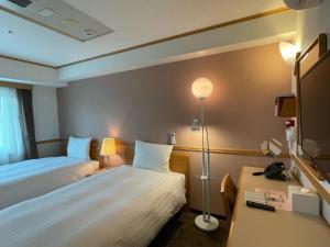 Postel nebo postele na pokoji v ubytování Toyoko Inn Busan Seomyeon
