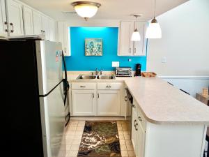 La cuisine est équipée d'un réfrigérateur blanc et d'un évier. dans l'établissement 700G-Spotless 2 bed 2 bath condo recently remodeled, à Myrtle Beach