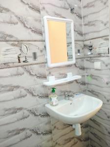 a bathroom with a sink and a mirror at Your House For Family in Agadir