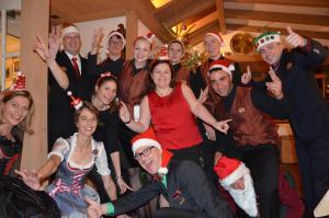 a group of people in christmas costumes posing for a picture at Eiger Mürren Swiss Quality Hotel in Mürren