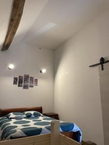 a bedroom with a bed and a cross on the wall at Gîte le Ch'armançon in Montigny-sur-Armançon