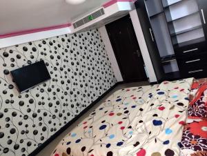 a bedroom with a bed with a black and white pattern at Festival mall apartments in Lagos