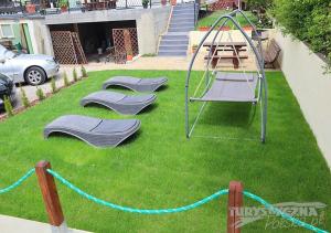 a playground in a yard with two empty swings at Ośrodek Wypoczynkowy Romed in Jastrzębia Góra