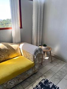 a couch in a room with a window and a table at Your Home away from Home in Pinetown