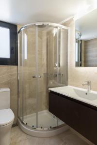 a bathroom with a shower and a sink and a toilet at Voda Luxury Residence #502 in Athens