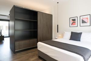 a bedroom with a large bed and a closet at Voda Luxury Residence #502 in Athens