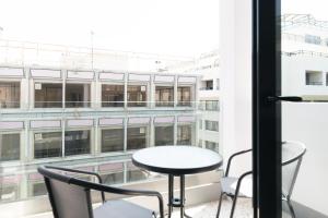 a table and chairs on a balcony with a view of a building at Voda Luxury Residence #502 in Athens