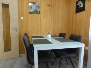 a conference room with a white table and black chairs at Apartment Lea in Maranza