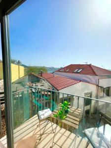 a balcony with a view of a house with a swimming pool at Foz Douro in Porto