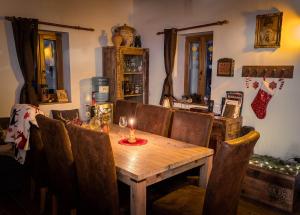 a dining room table with a candle on top of it at Kispince Wellness Borbirtok in Böhönye +11 photos