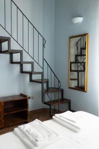 a bedroom with a staircase next to a bed at La Stalla de La Costa in Asciano