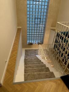 a staircase in a house with a large window at Pension COLUMBIA inkl. Frühstück im Zentraum in Bad Gleichenberg