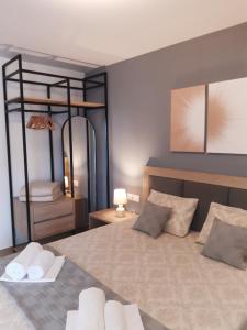 a bedroom with a large bed with two pillows at Studio Wilem in Sarti
