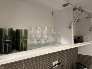 a row of wine glasses sitting on a shelf at Apartman MN Teslic in Teslić