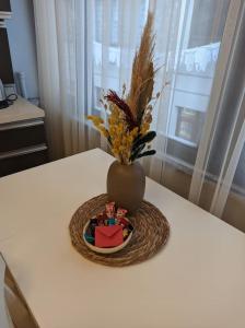 a vase sitting on top of a table with a basket at Modern Apartment in the Heart of the City - Fatih in Istanbul