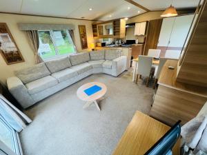 a living room with a couch and a table at Luxury 2 Bedroom Caravan LG13, Shanklin, Isle of Wight in Shanklin