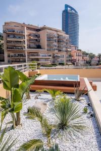 a balcony with palm trees and a pool on a building at Penthouse Exceptionnel vue Mer proche Monaco in Beausoleil
