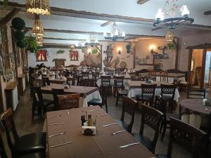 a restaurant with tables and chairs in a room at Viva 5 apartment Grand Monastery on the ski slopes in Pamporovo