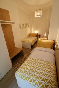 A bed or beds in a room at Valtellina Vacanze