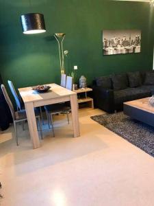 ein Wohnzimmer mit einem Tisch und einem Sofa in der Unterkunft Apartment „La Casa de Papel“ / Behindertengerecht in Leipzig