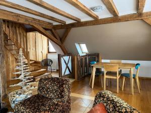 a living room with a table and chairs at Le Saint Michel in Otterswiller