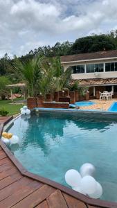 a swimming pool with white balls in the water at Sítio Maranata Vale das Montanhas in Monte Alegre do Sul