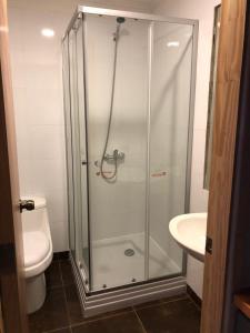 a glass shower in a bathroom with a toilet at Cabañas Anahuac II in Puerto Montt +27 photos