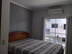 Cama o camas de una habitación en Apartamento Ingleses Florianópolis