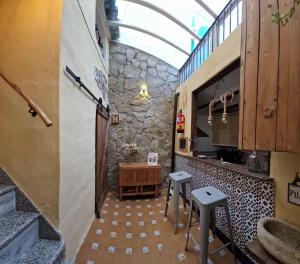 a kitchen with a counter and stools in a room at Casa Cuartel in El Gastor +37 photos