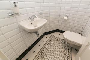 a white bathroom with a sink and a toilet at New apartment 2 - self check in, free parking in Bratislava