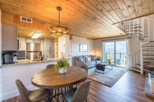 a kitchen and living room with a wooden ceiling at Smoky Sunrise Getaway in Gatlinburg