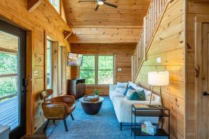 a living room in a log cabin with a couch and chairs at Mountain Mist in Gatlinburg