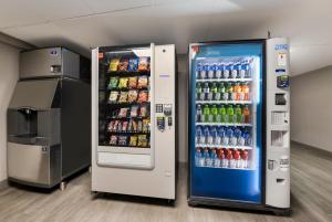 uma máquina de venda automática cheia de refrigerantes e bebidas em Essence Express Wayne em Wayne