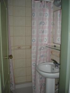 a bathroom with a sink and a shower curtain at Parkmar Apart in Marmaris