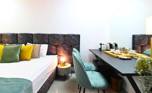 a bedroom with a bed and a table with a tableablish at Yalarent Malina motel in Tiberias in Tiberias