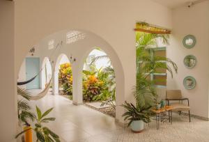 an arched hallway with plants in a building at Casa Celeste Honda in Honda