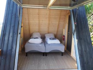 a bed in the inside of a tiny house at BaseCamp Vega in Sundsvoll