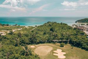 an aerial view of a golf course and the ocean at Modern Tropical Luxe Apartment - Ilig-Iligan Beach in Boracay