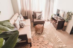 a living room with a couch and a chair at Modern Tropical Luxe Apartment - Ilig-Iligan Beach in Boracay