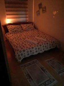 a bedroom with a bed with a white comforter at Apartment Mirror in Visoko