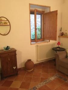 a living room with a couch and a window at La casa di Tiziana in Villalago