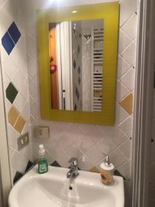 a bathroom with a sink and a mirror at La casa di Tiziana in Villalago