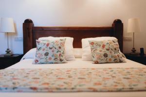 a bedroom with a bed with two pillows on it at Can Serrete in Sineu