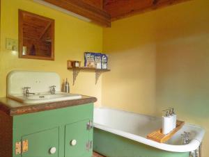 a bathroom with a sink and a bath tub at Adirondack Cottage Retreat in Elizabethtown +14 photos