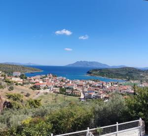 a town on a hill with the ocean in the background at Nera's view in Ancient Epidauros