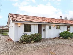 a small white house with a red roof at 10 person holiday home in B rkop in Egeskov