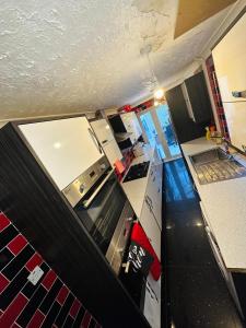 a view of a kitchen with white counters and appliances at Double Room with Private Shower room Close to City center and UOB Free Onsite Parking Private Fridge with Shared Kitchen and Lounge access in Northfield