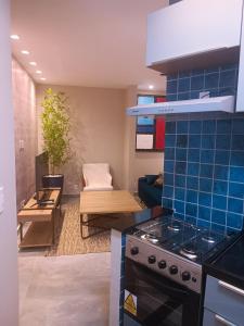 a kitchen with a stove top oven next to a living room at PIRAGIBE FROTA AGUIAR in Rio de Janeiro